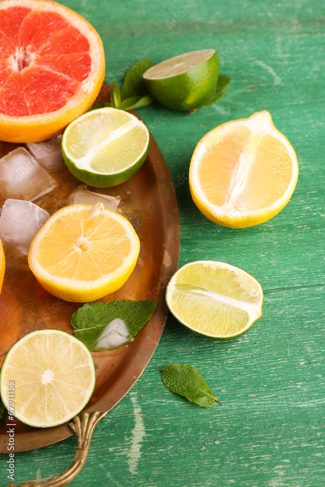 Different sliced juicy citrus fruits with ice Different sliced juicy citrus fruits with ice