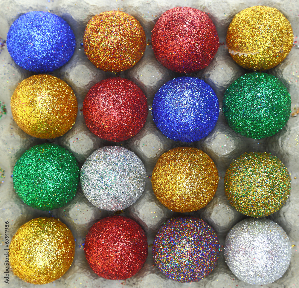 Colorful glitter eggs in carton egg packaging