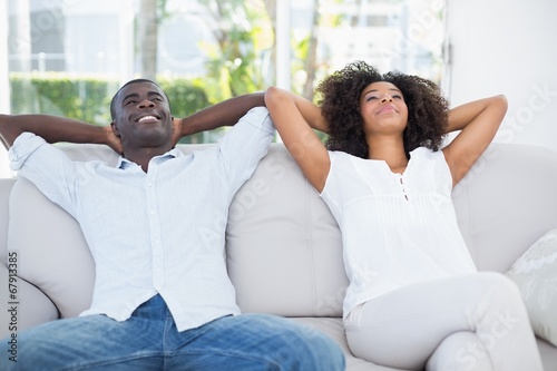 Attractive couple relaxing on couch together