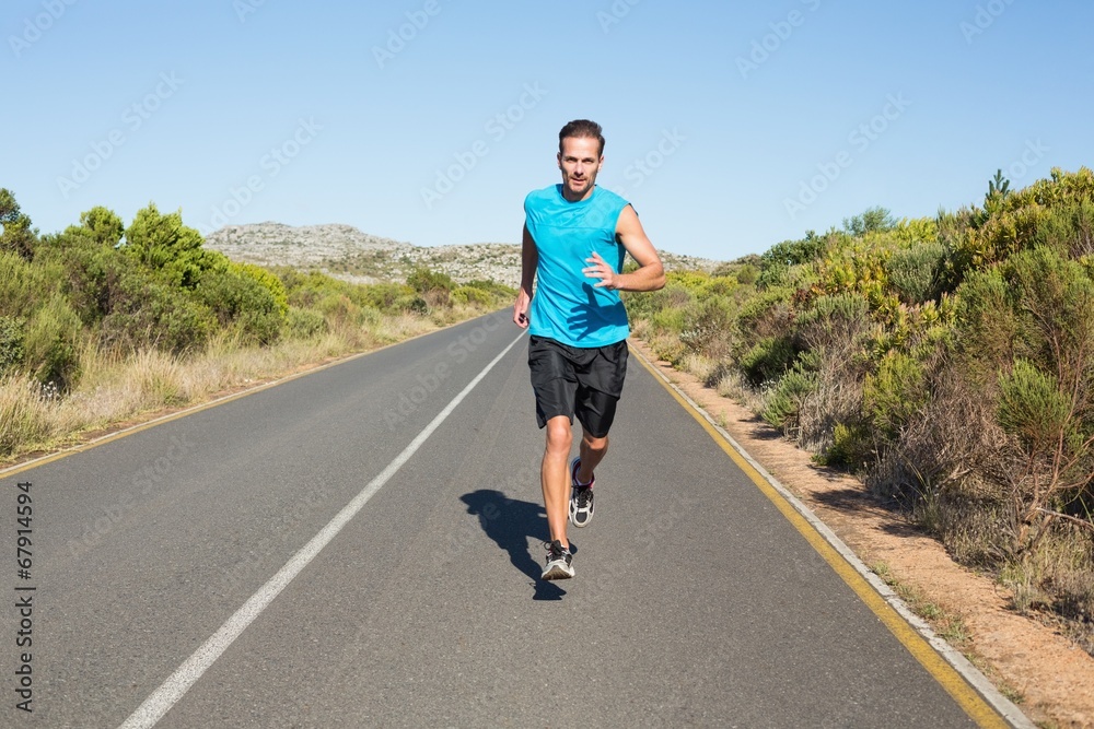 Fit man jogging on the open road Fit man jogging on the open road