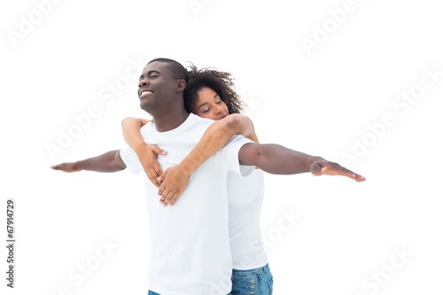 Casual couple standing with arms outstretched