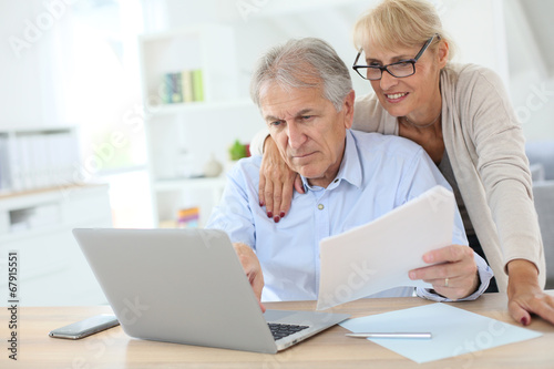 Senior couple doing the income tax declaration online photo