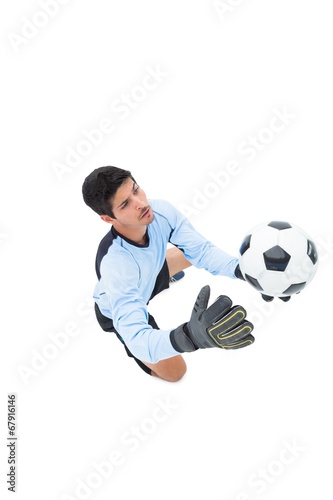 Goalkeeper in blue making a save