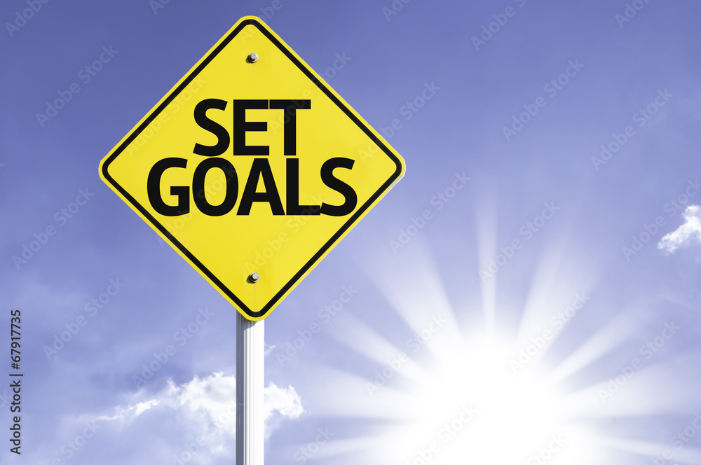 Set Goals road sign with sun background