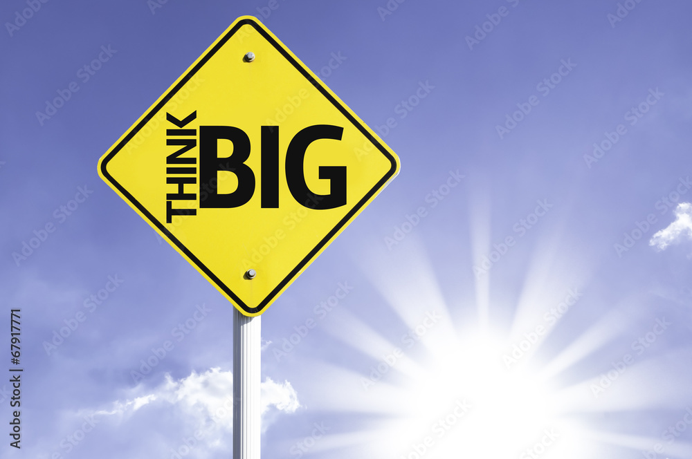 Think Big road sign with sun background