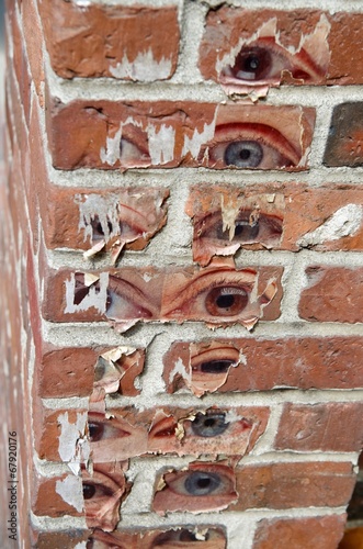 Human's eyes on the brick wall