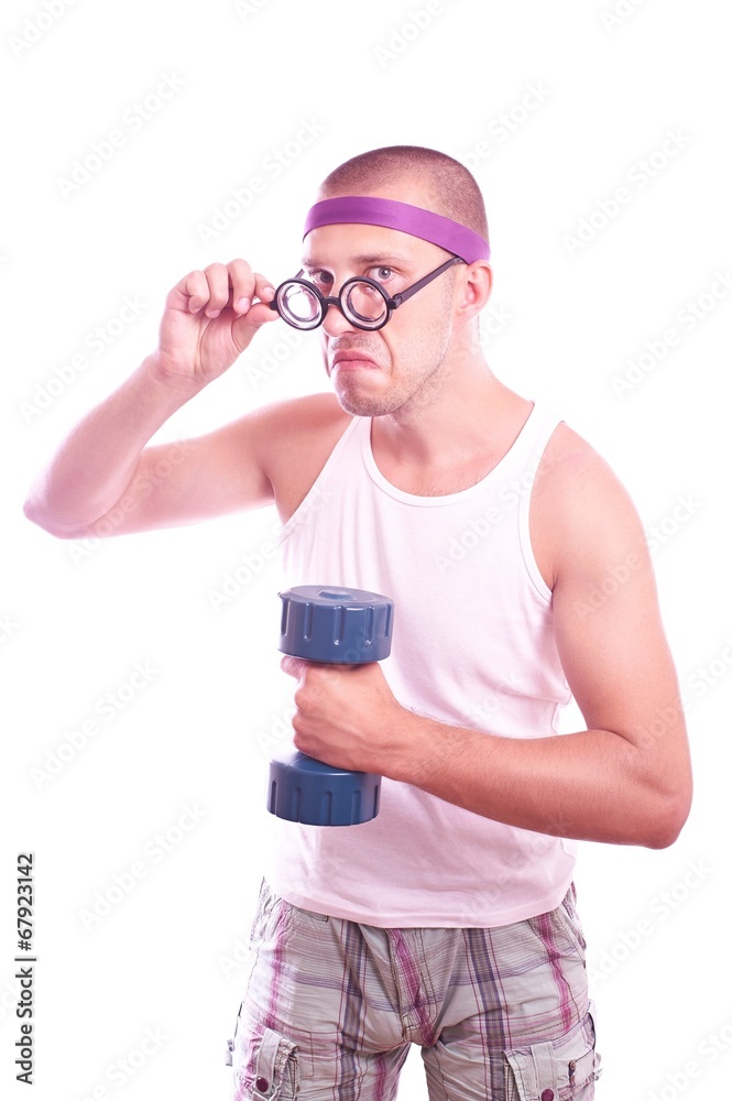 Nerd in glasses with dumbbell trains Nerd in glasses with dumbbell trains
