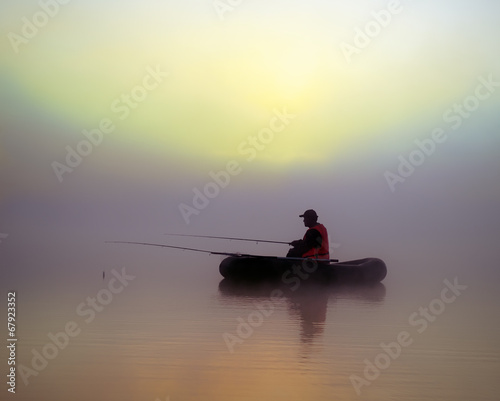 The fishermen on the boat in the fog