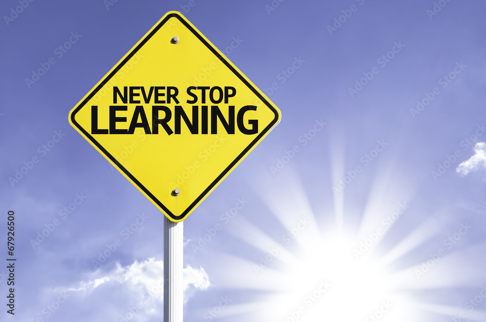 Never Stop Learning road sign with sun background Never Stop Learning road sign with sun background
