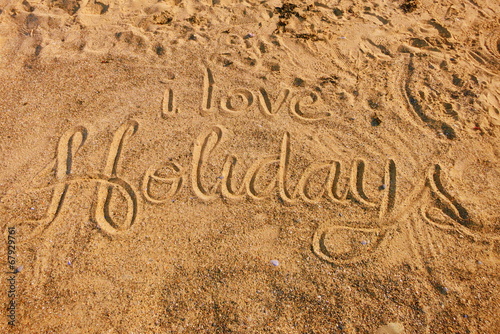 I love Holidays written in golden sand (vacation summer)