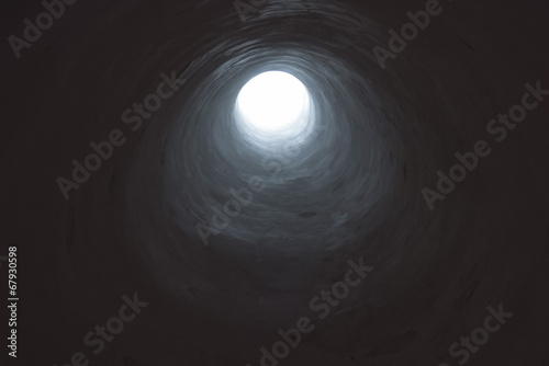 Dark tunnel leading into light opening.