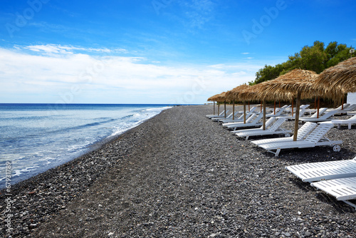 Fototapeta Naklejka Na Ścianę i Meble -  The beach with black volcanic stones at Santorini island, Greece