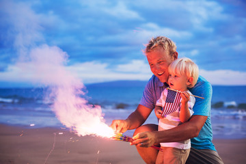 Father and son lighting fireworks