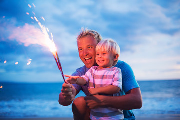 Father and son lighting fireworks