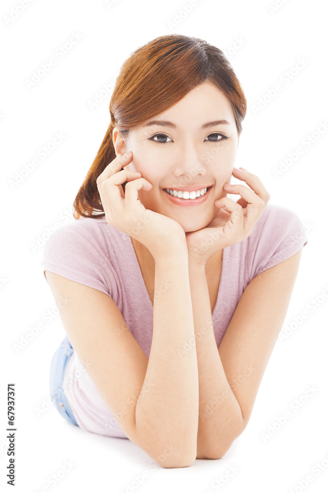 closeup of smiling young woman lying prone on the floor closeup of smiling young woman lying prone on the floor