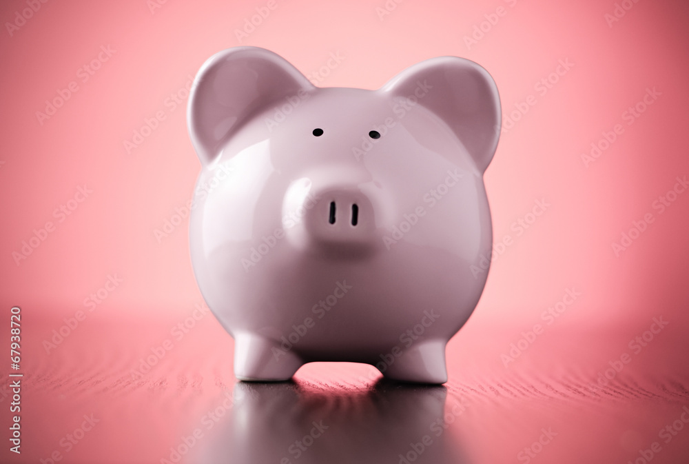 Pink piggy bank on a colorful red background
