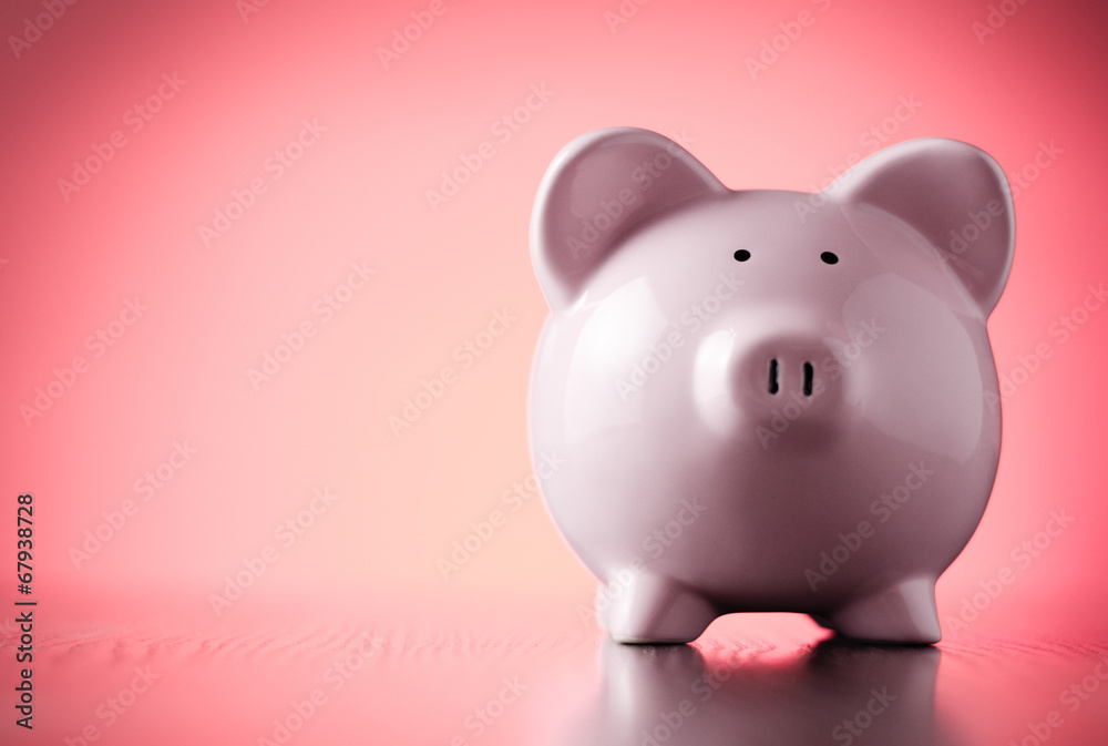 Pink piggy bank on a colorful red background