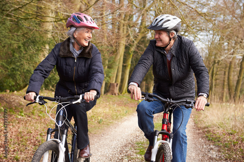 Senior Couple On Cycle Ride In Winter Countryside