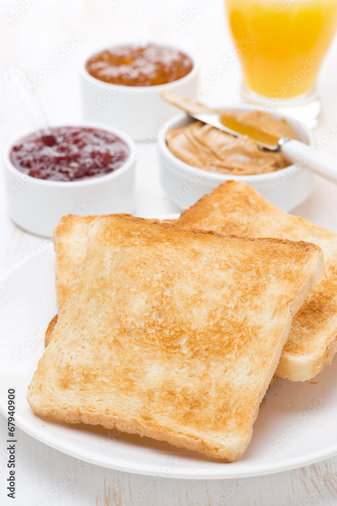 toast with various jams and peanut butter, orange juice