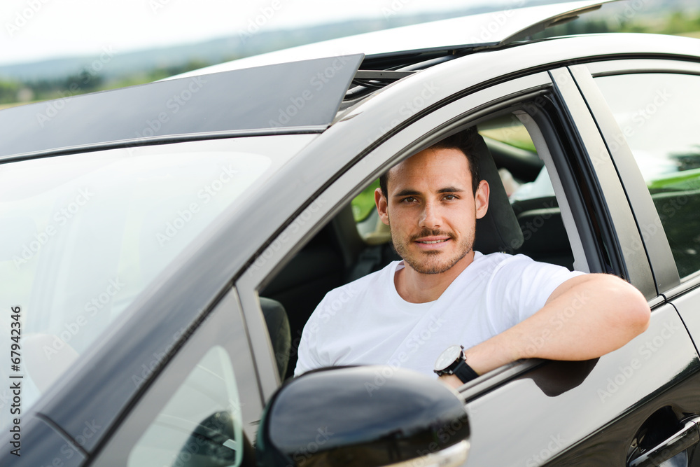 handsome young man driving new car countryside summer vacation