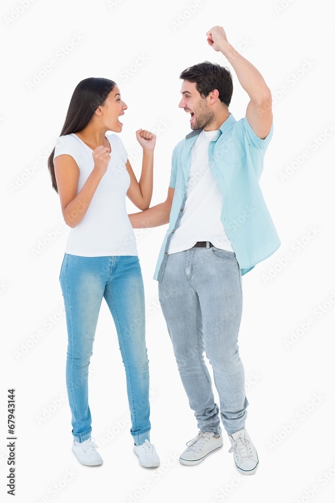 Fototapeta premium Happy casual couple cheering together