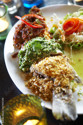 close up thai fish curry fried in ceramic dish