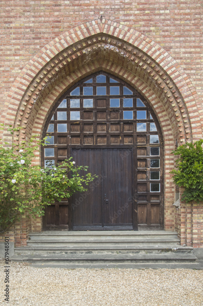 old wooden door with glass and brick surround