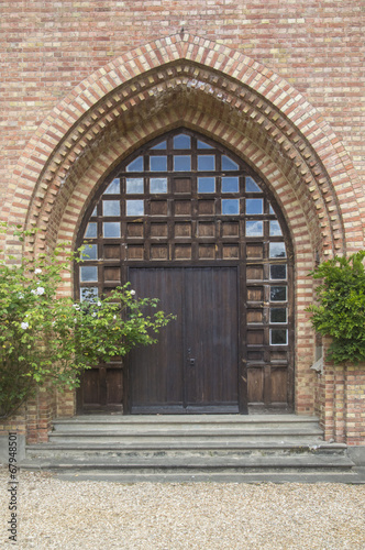 old wooden door with glass and brick surround