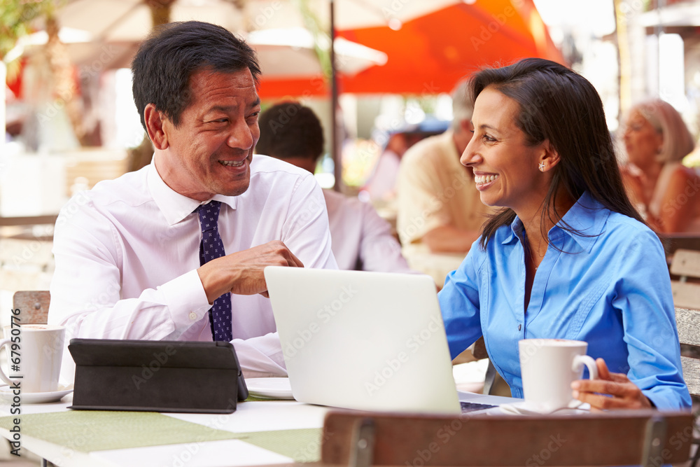 Two Businesspeople Having Meeting In Outdoor Cafe Two Businesspeople Having Meeting In Outdoor Cafe