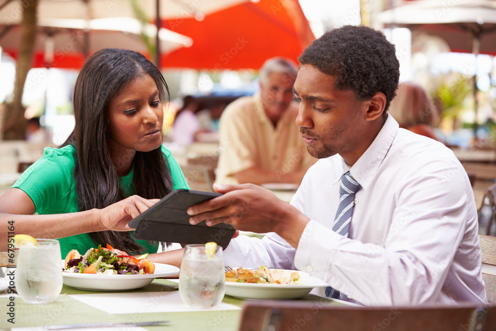 Two Businesspeople Having Meeting In Outdoor Restaurant