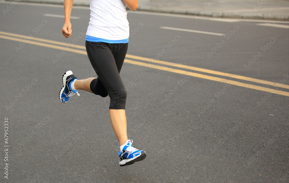 Runner athlete running on city road.  