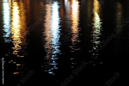 Colorful lights reflecting on sea surface