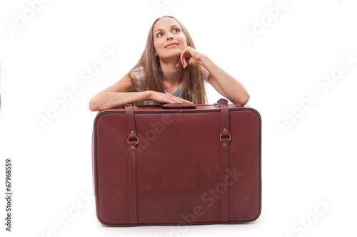 girl sitting near a suitcase