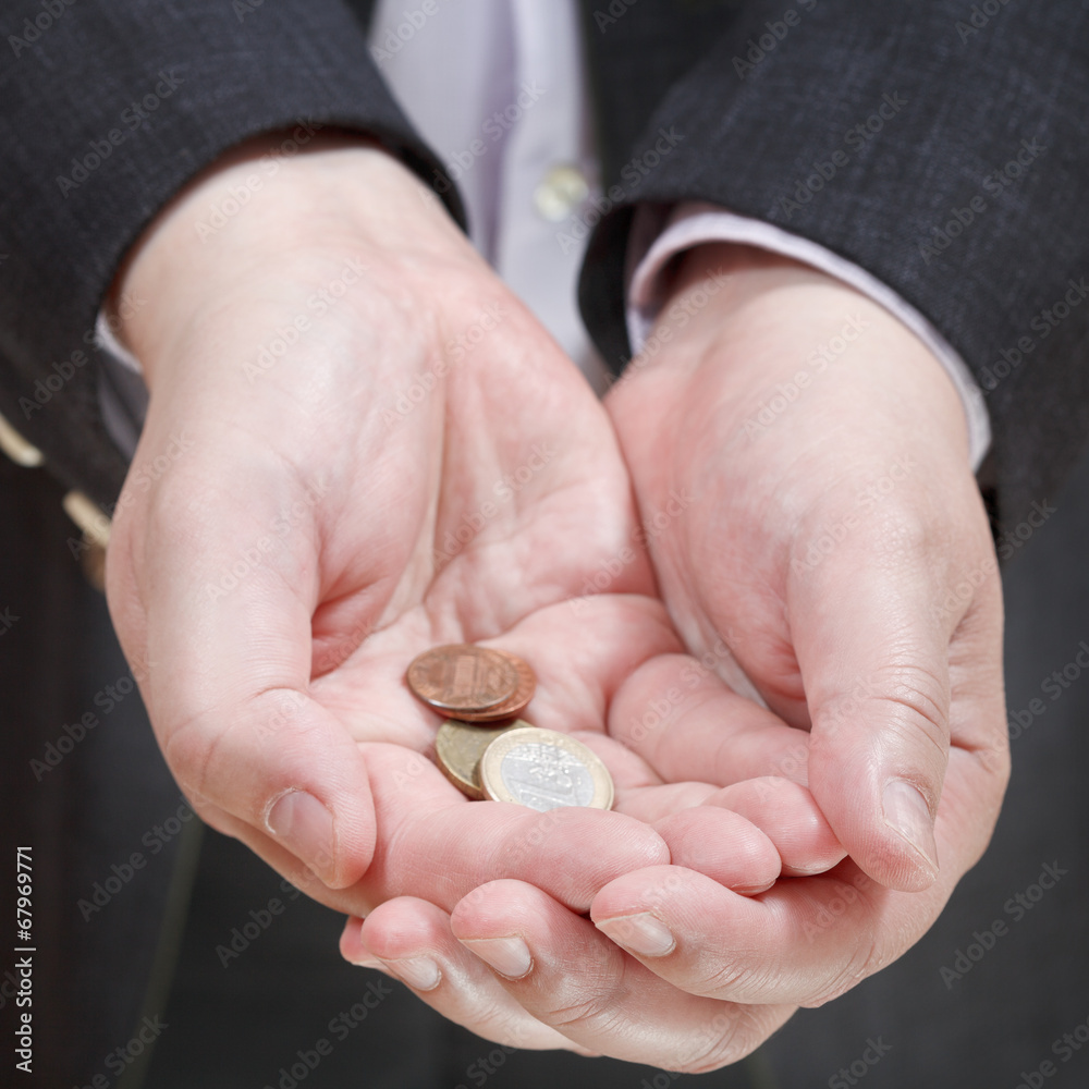 little of coins in businessman's handful