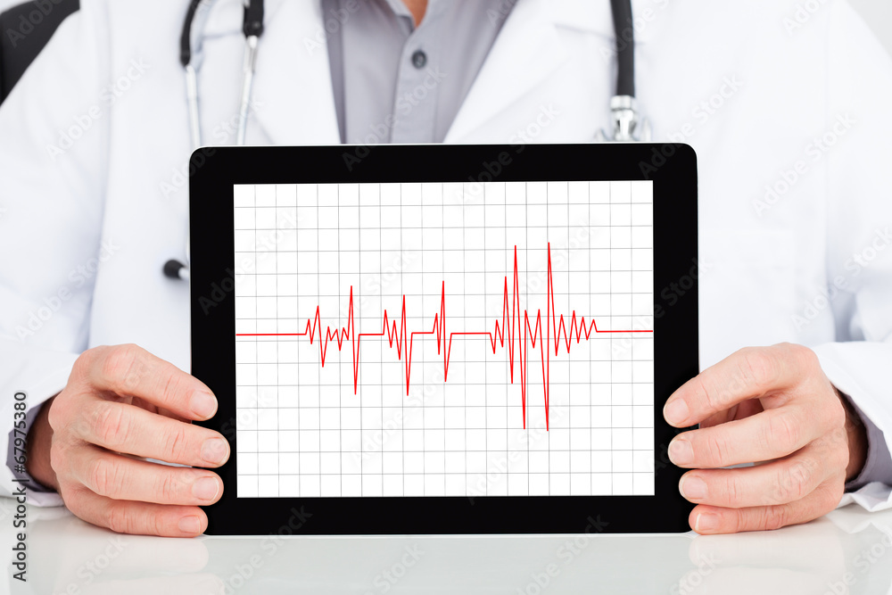 Doctor Showing Heartbeat On Digital Tablet Doctor Showing Heartbeat On Digital Tablet