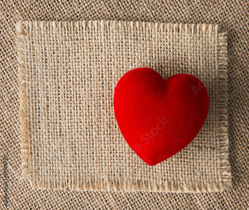 Red heart on burlap, sackcloth background. Valentines Day