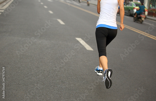Runner athlete running on city road. 