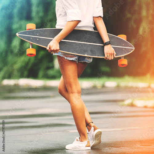 Fashion lifestyle, beautiful young woman with longboard. Lightle photo