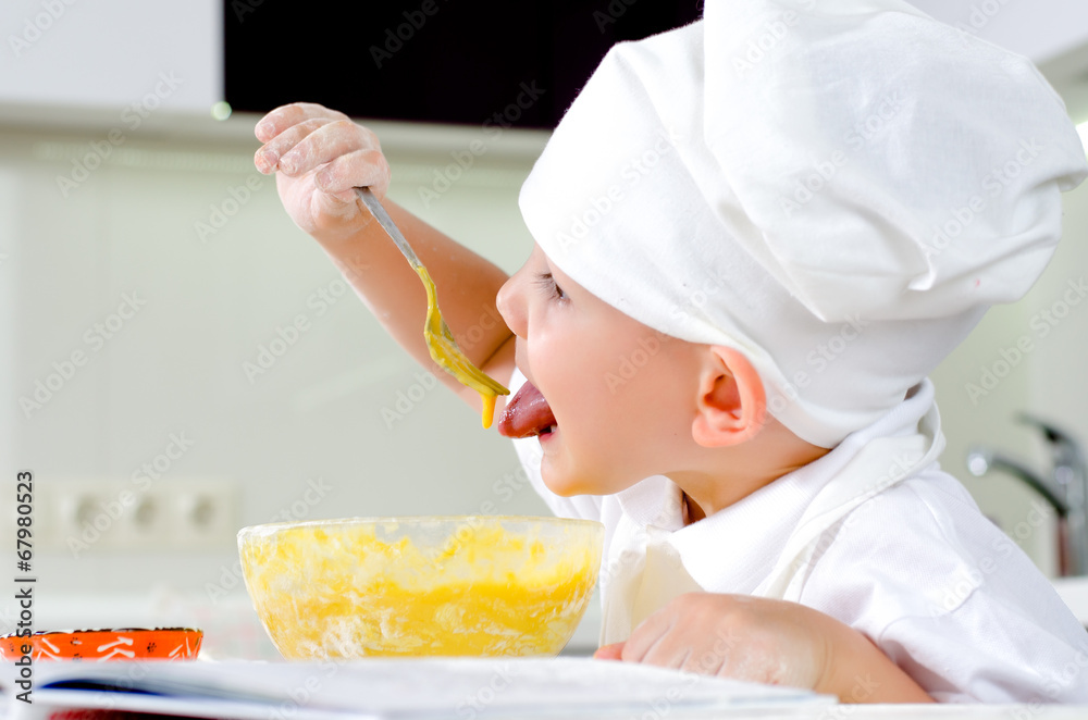 Cute little chef tasting his cooking Cute little chef tasting his cooking