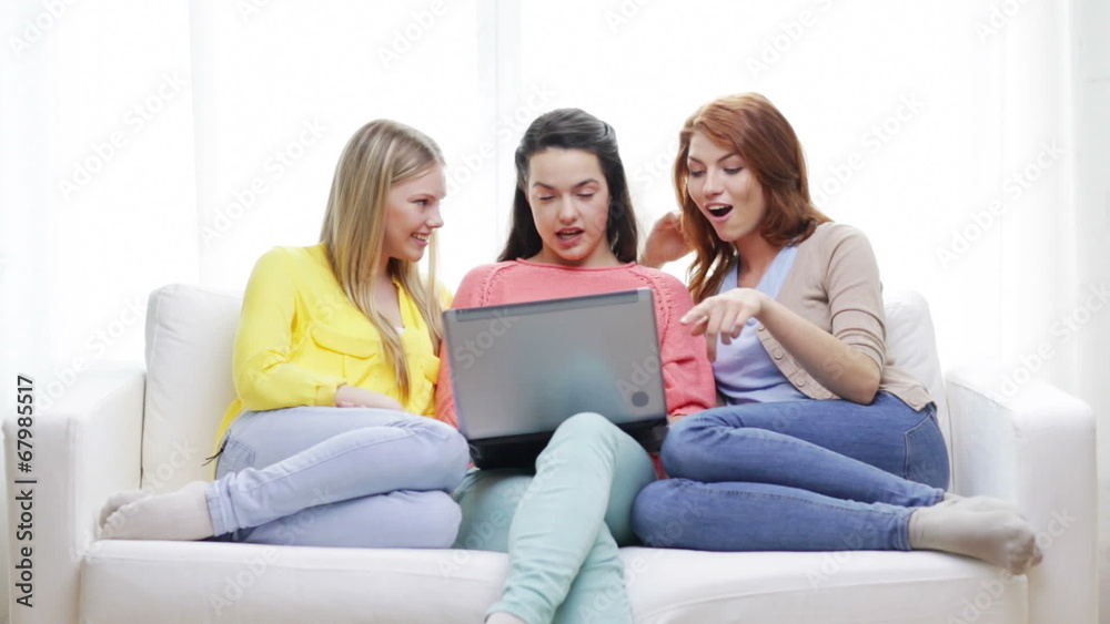 three smiling teenage girls with laptop at home three smiling teenage girls with laptop at home