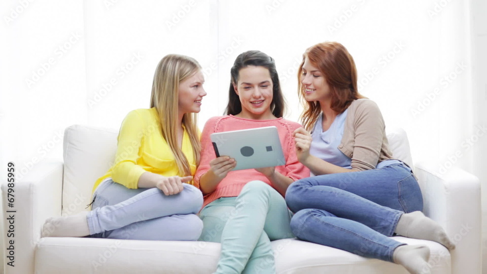 two smiling teenage girls with tablet pc at home two smiling teenage girls with tablet pc at home