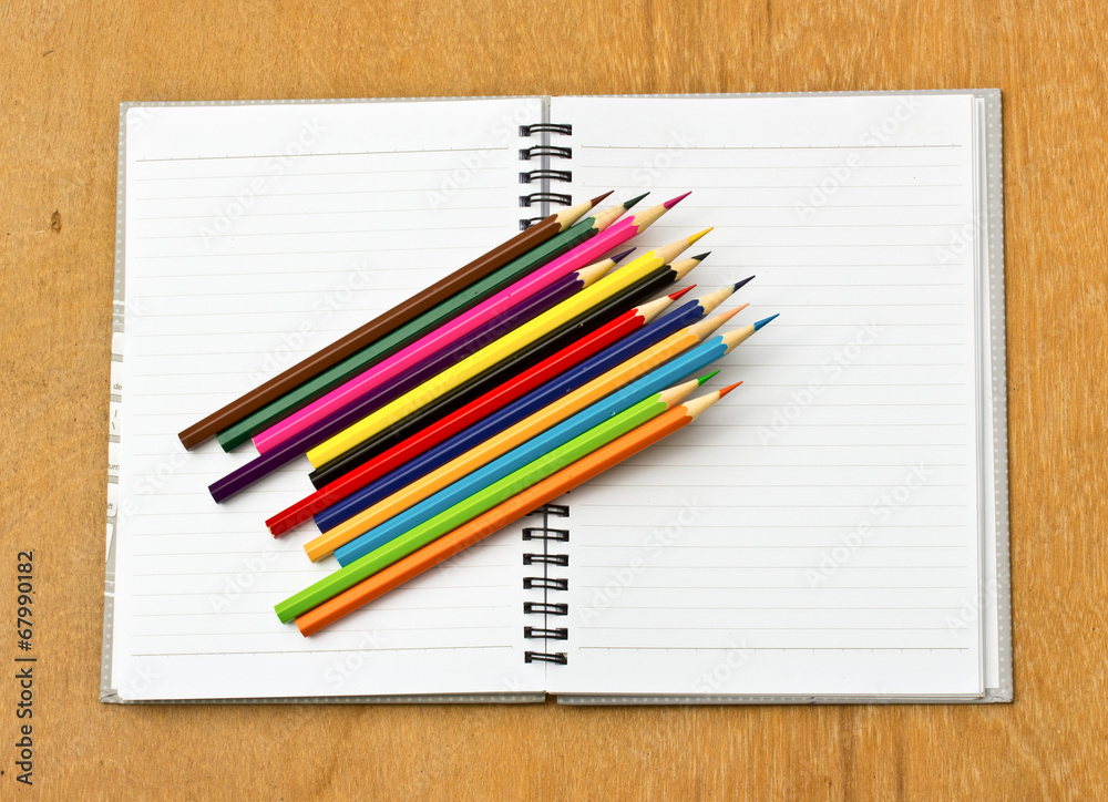 colorful pencil and notebook on wood background colorful pencil and notebook on wood background
