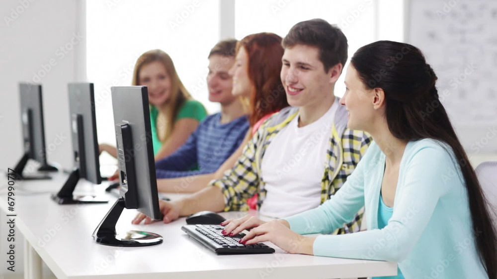 smiling students working with computers at school smiling students working with computers at school