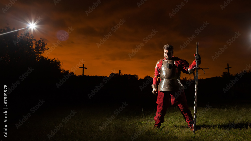 Medieval knight in the armor with the sword