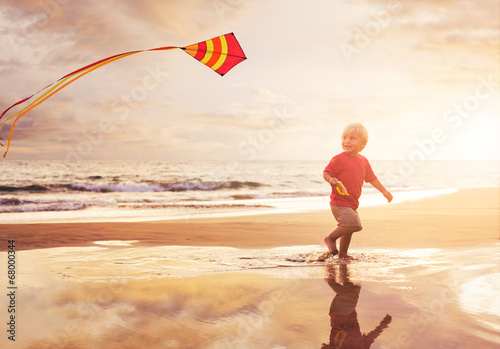 Young boy playing with kite photo