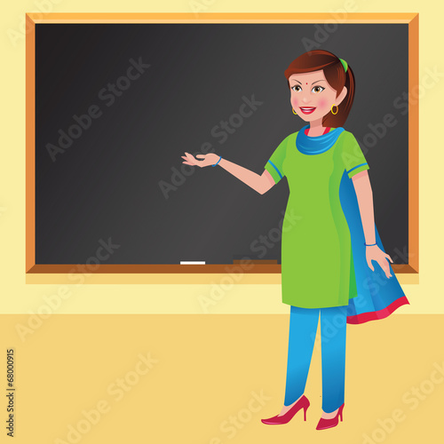 Indian woman teacher in front of a blackboard