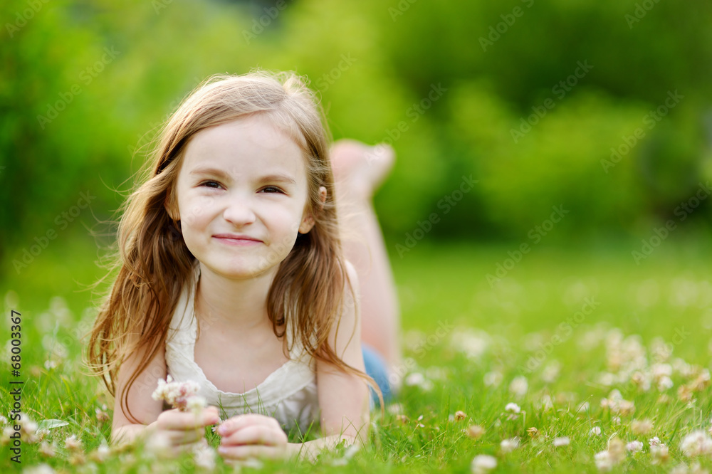 Cute little girl laying in the grass