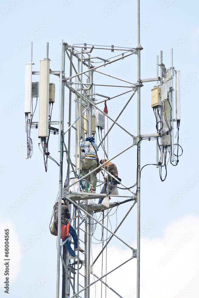 Technician working on communication towers Technician working on communication towers