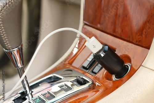 USB charger plug with charging cable on a car