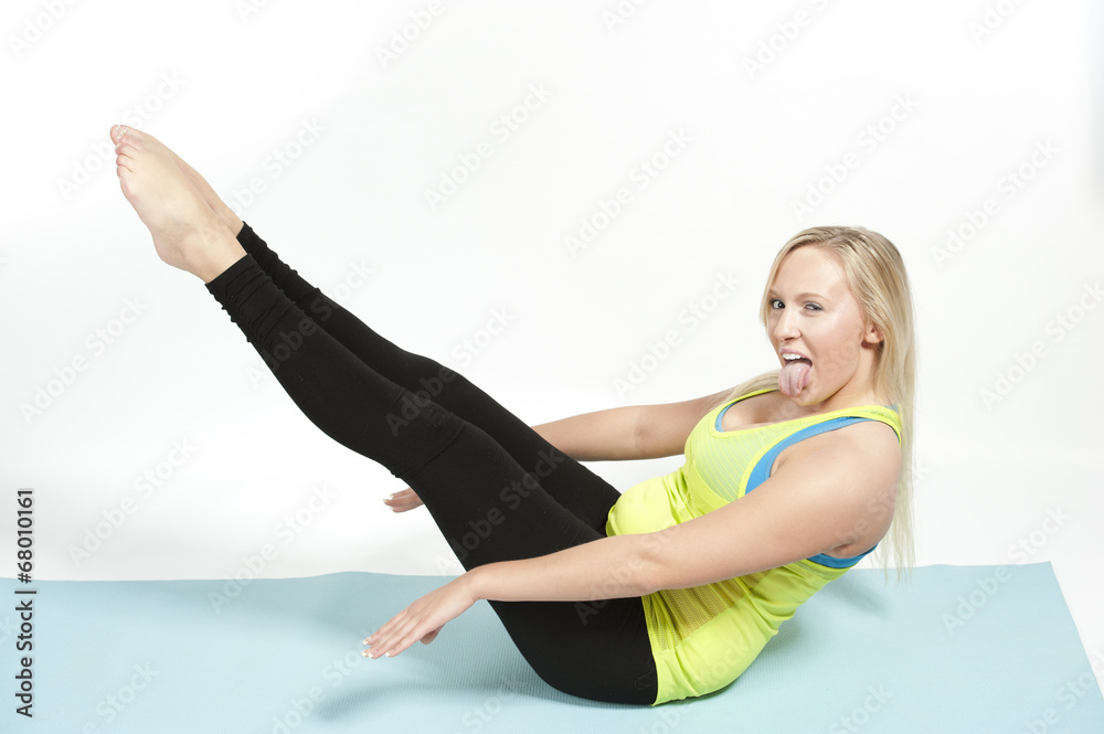 Young female model showing the full boat pose in yoga - also known as Paripurna Navasana. Young female model showing the full boat pose in yoga - also known as Paripurna Navasana.
